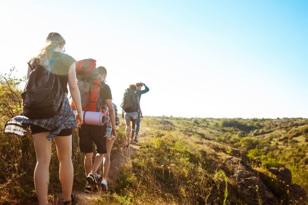 young-beautiful-friends-travelers-with-backpacks-walking-canyon (1) (1)